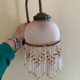 Pair of wall sconces in pink glass and pendants.