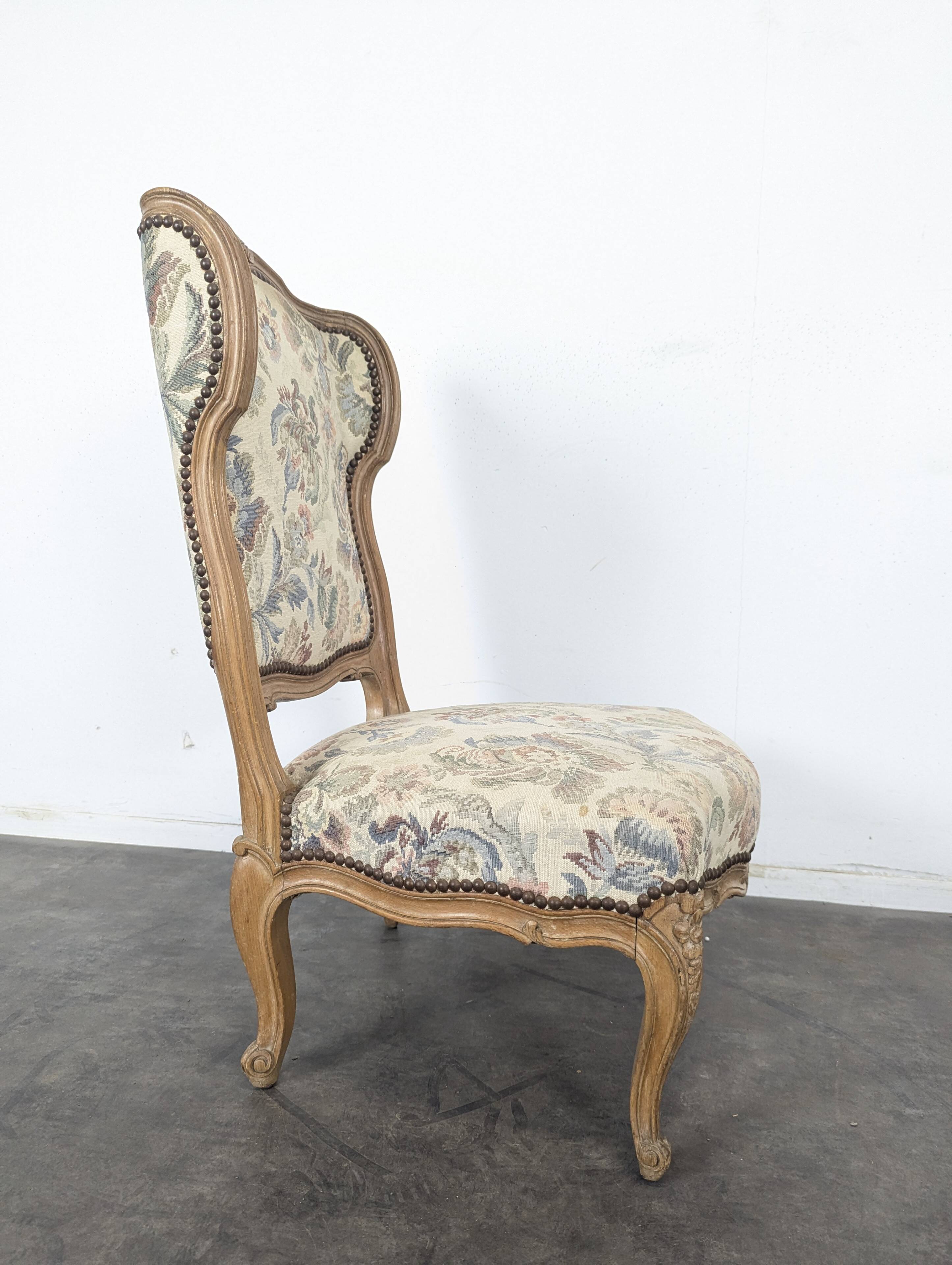 Louis XV style armchair in natural wood with floral fabric.