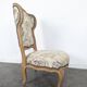 Louis XV style armchair in natural wood with floral fabric.