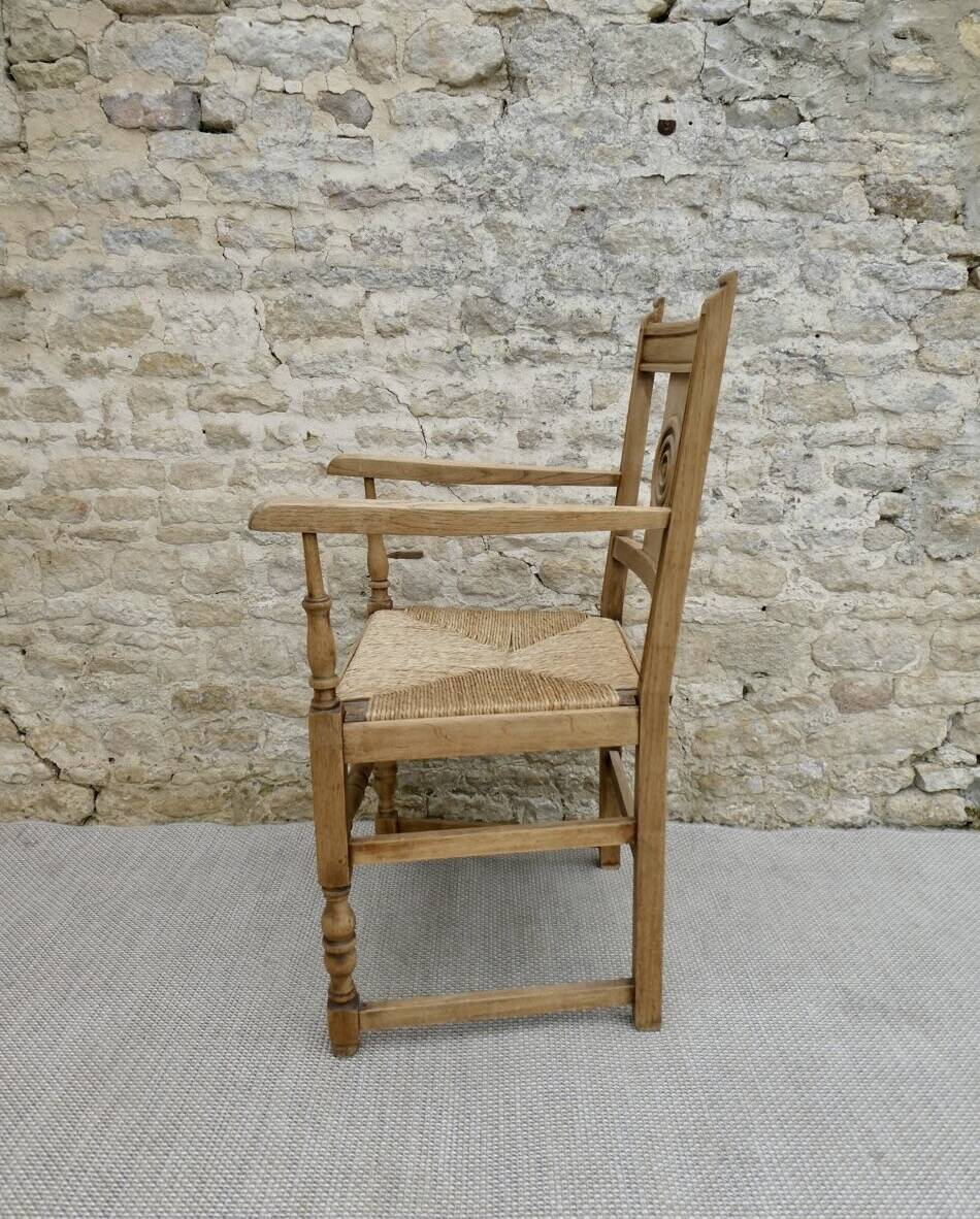 Light wood neo-Basque armchair with caned seat.