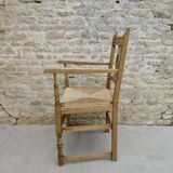 Light wood neo-Basque armchair with caned seat.