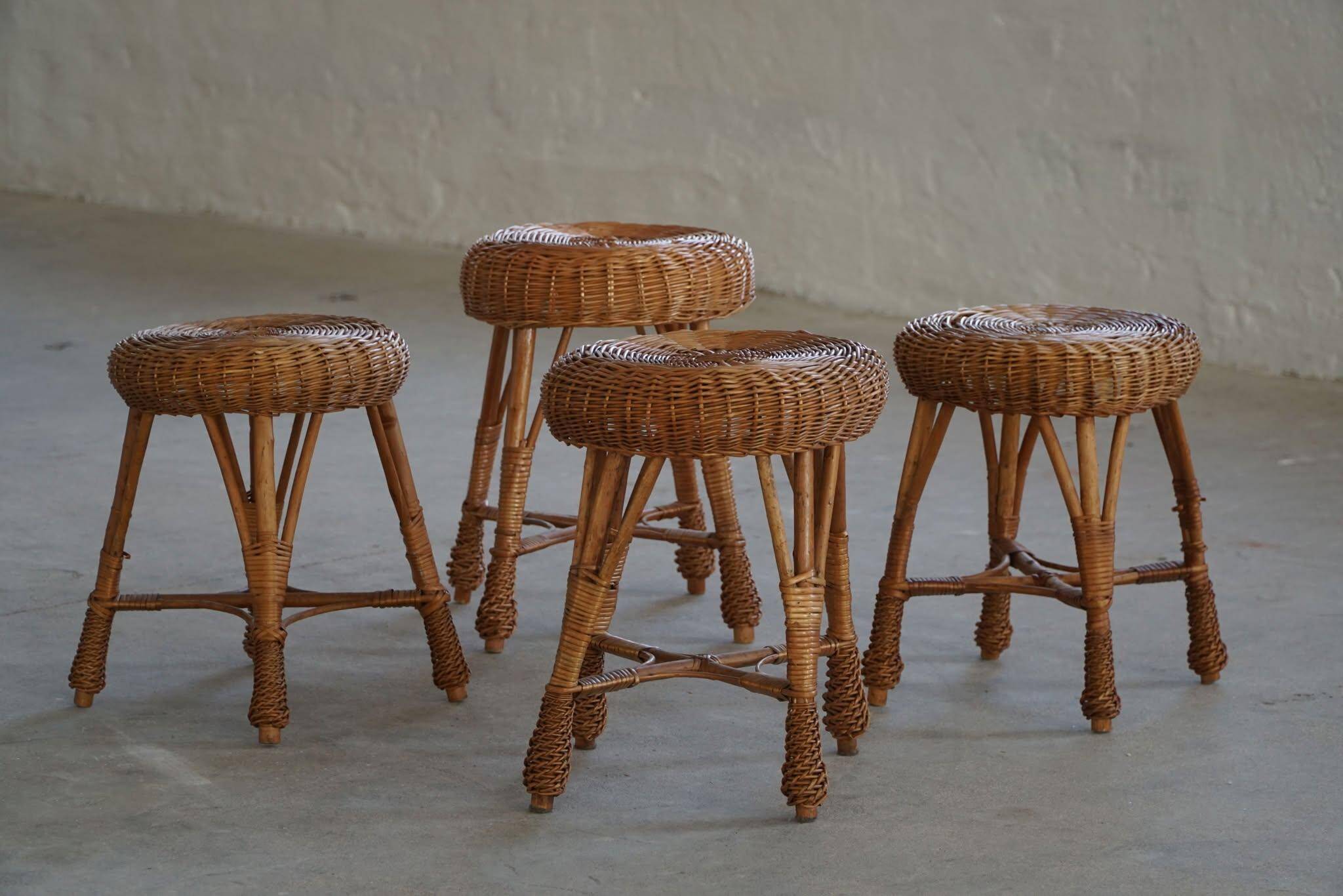 A set of 4 vintage Scandinavian rattan stools, in the style of Tony Paul, from the 1960s.
