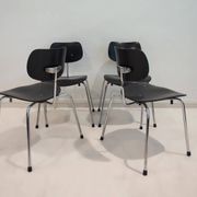 Set of four Egon Eiermann model SE 68 chairs in black lacquered plywood and steel.