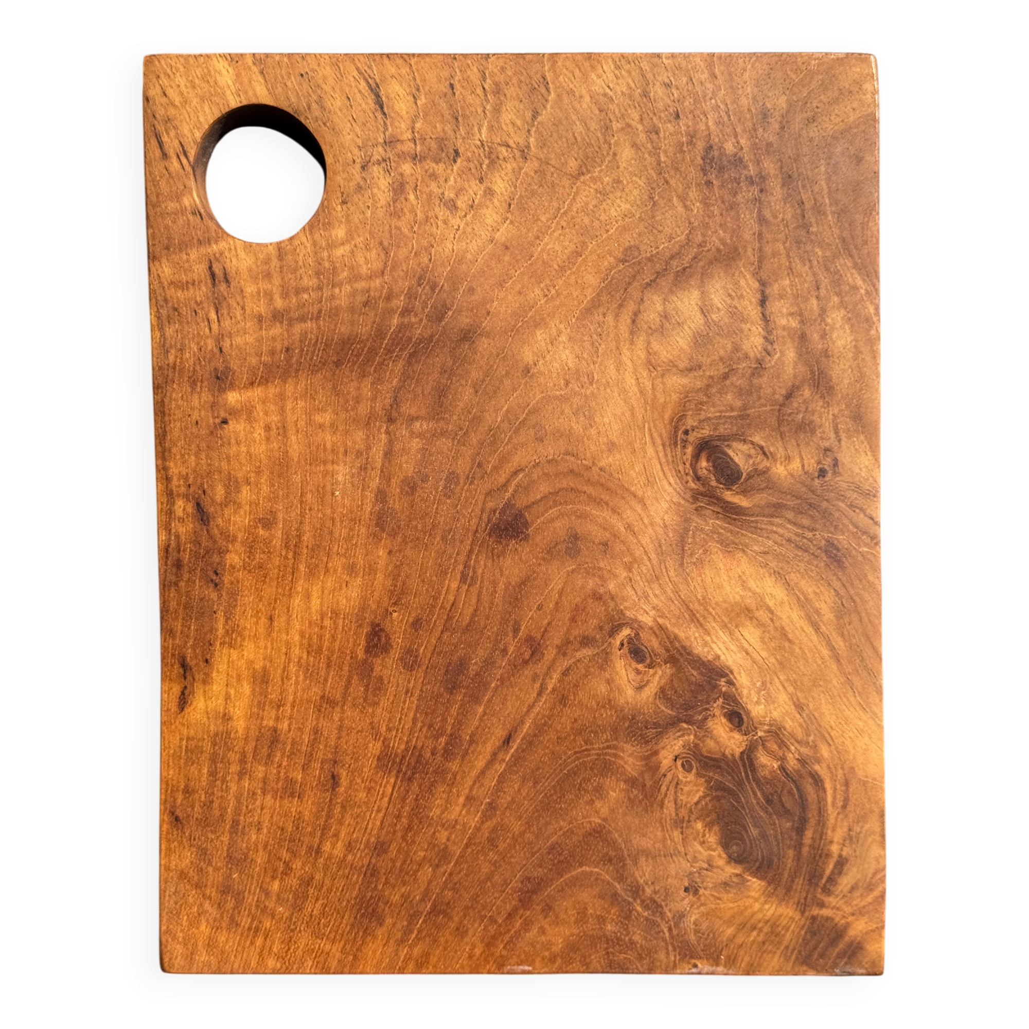 Small rectangular teak monoxyle cutting board with a circular handle.