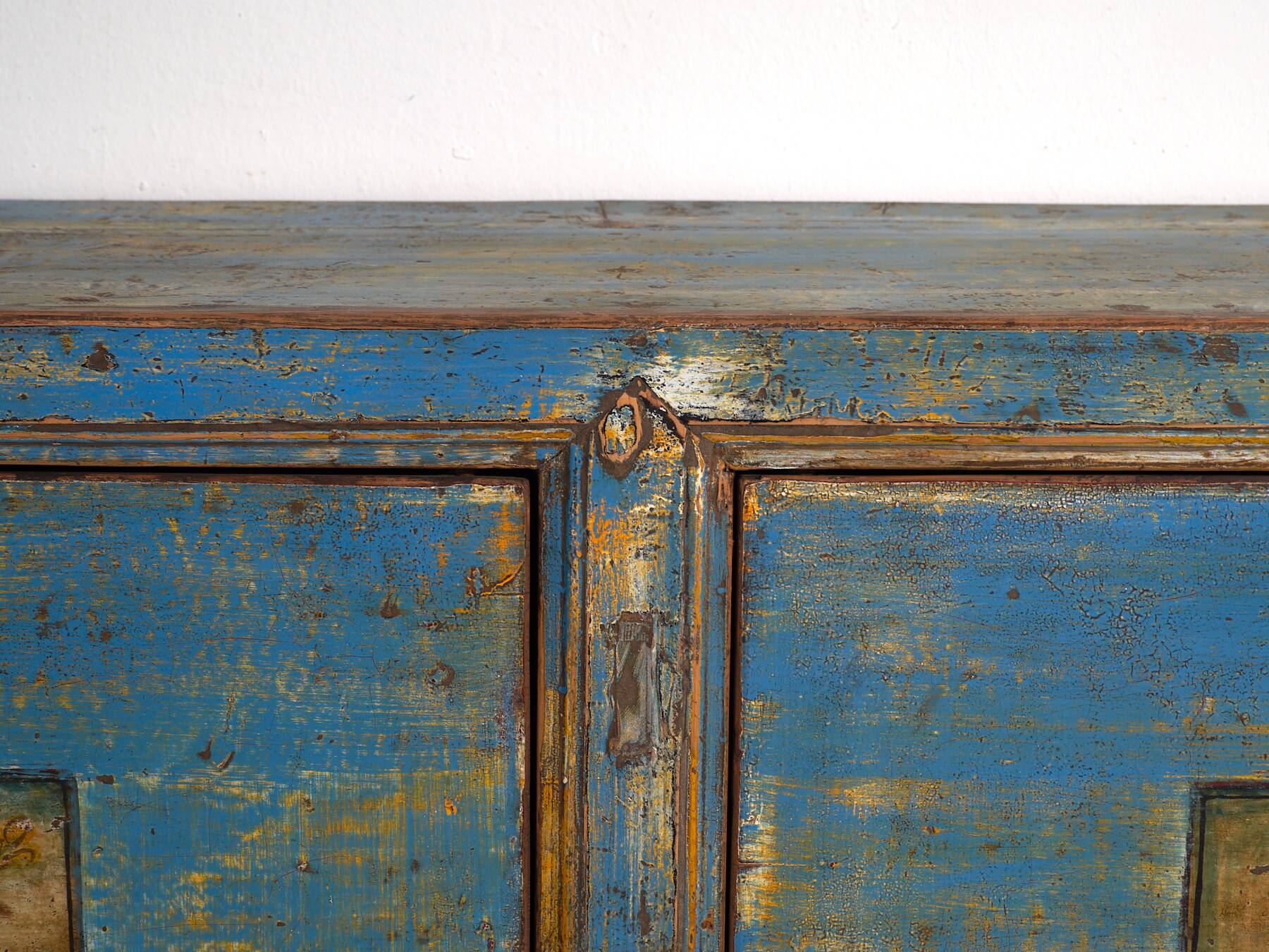 Old wooden entrance buffet in blue and yellow tones (circa 1920).