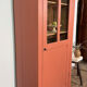 Antique glass-fronted terracotta cupboard