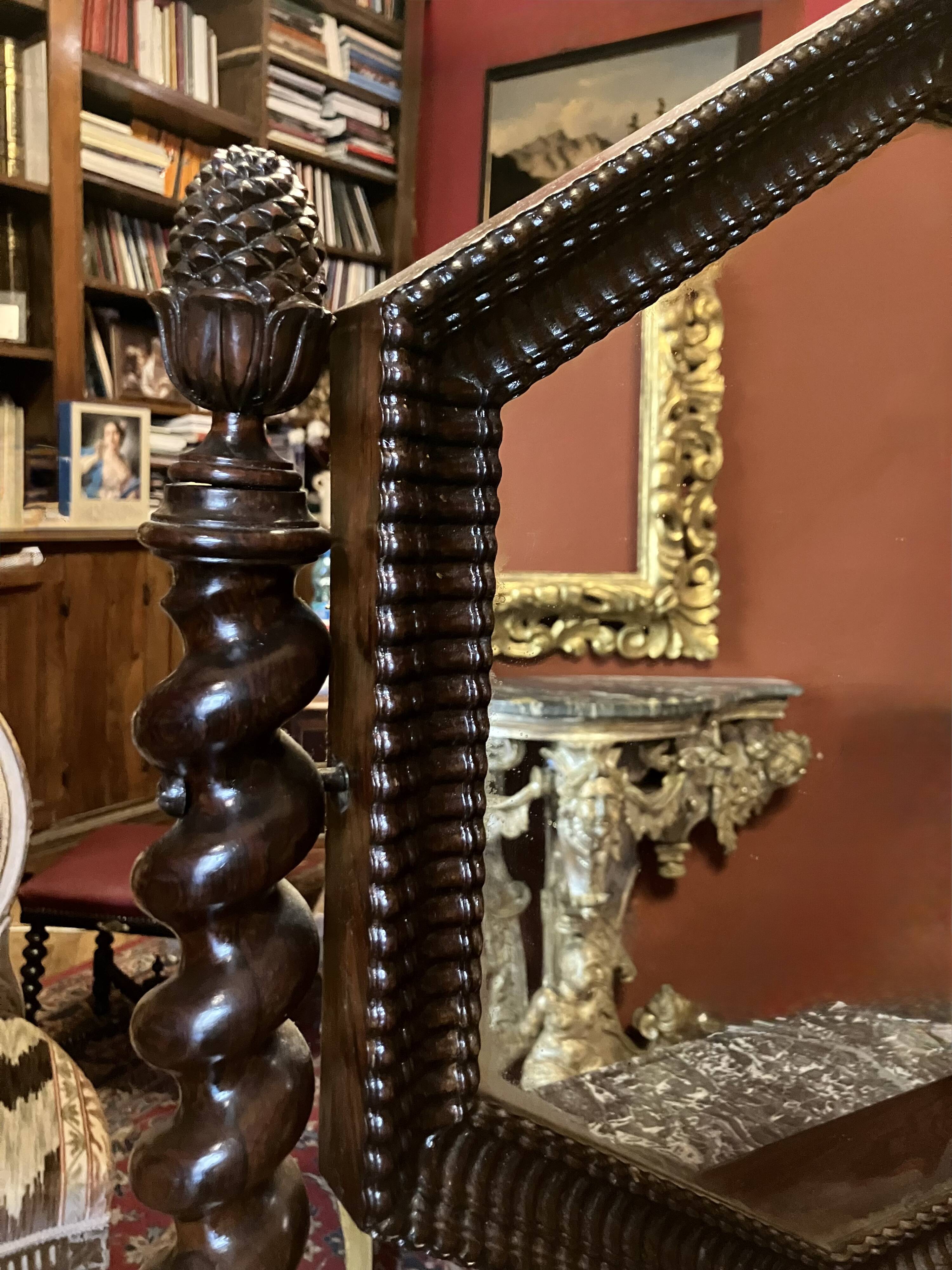 Antique English mahogany dressing table with carved details, black marble, and mirror.
