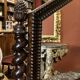 Antique English mahogany dressing table with carved details, black marble, and mirror.