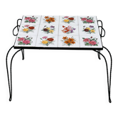 Vintage coffee table in wrought iron with floral tiles.