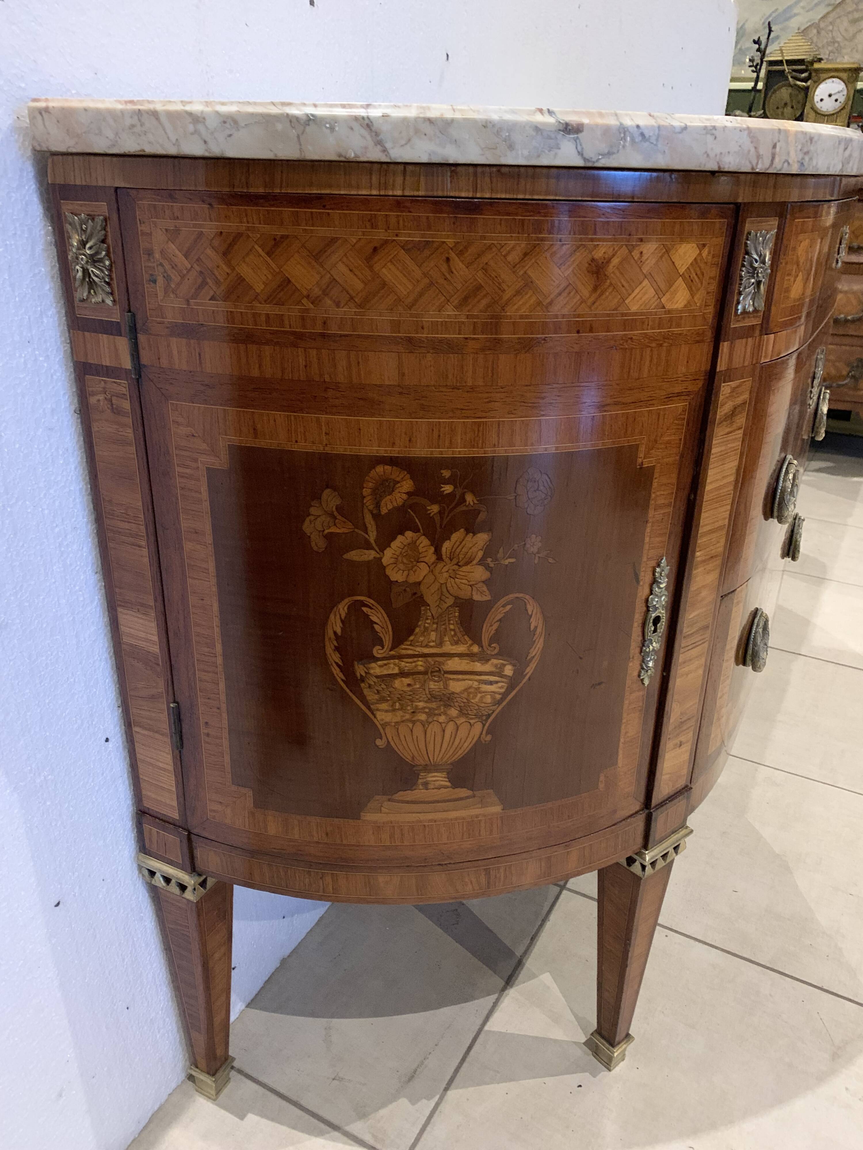 Louis XVI style half-moon chest of drawers in late nineteenth century marquetry