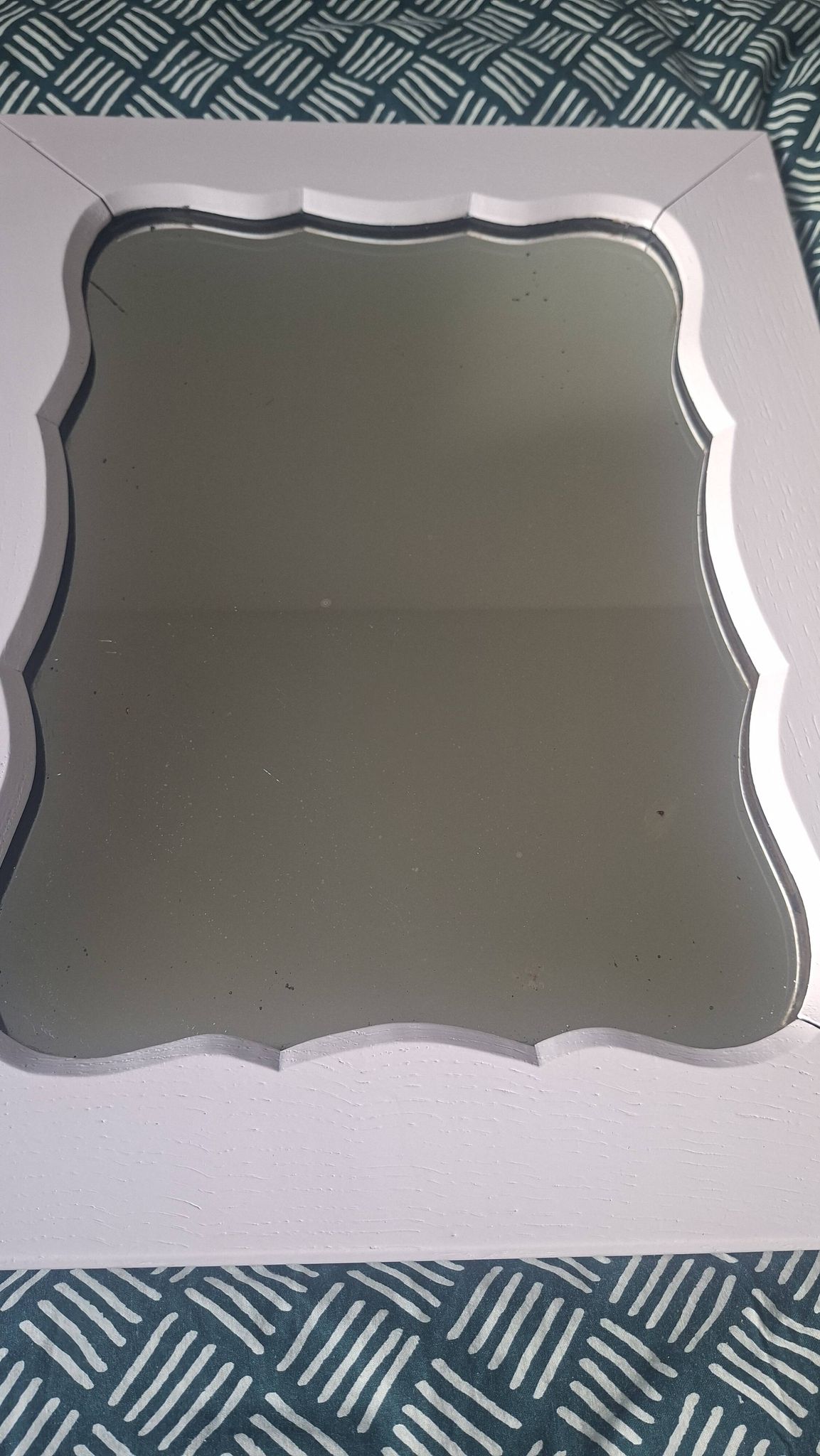 Mid-20th century rectangular wall mirror with a powder pink frame.