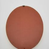 Small old oval mirror in gilded wood