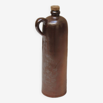 Old enamelled brown sandstone bottle with cork stopper