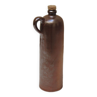 Old enamelled brown sandstone bottle with cork stopper