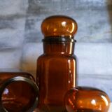 Duo of vintage apothecary bottles in amber glass