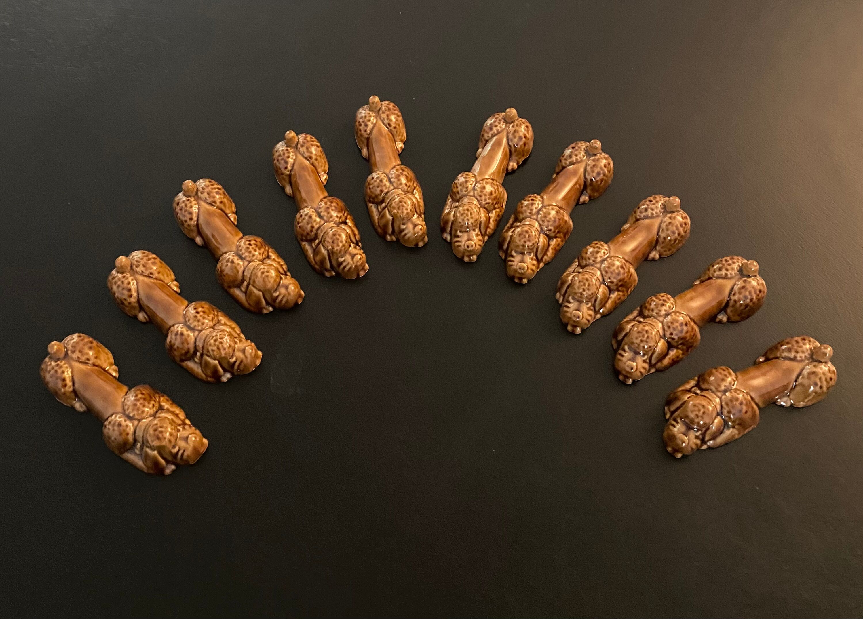10 ceramic knife holders in the shape of a recumbent poodle