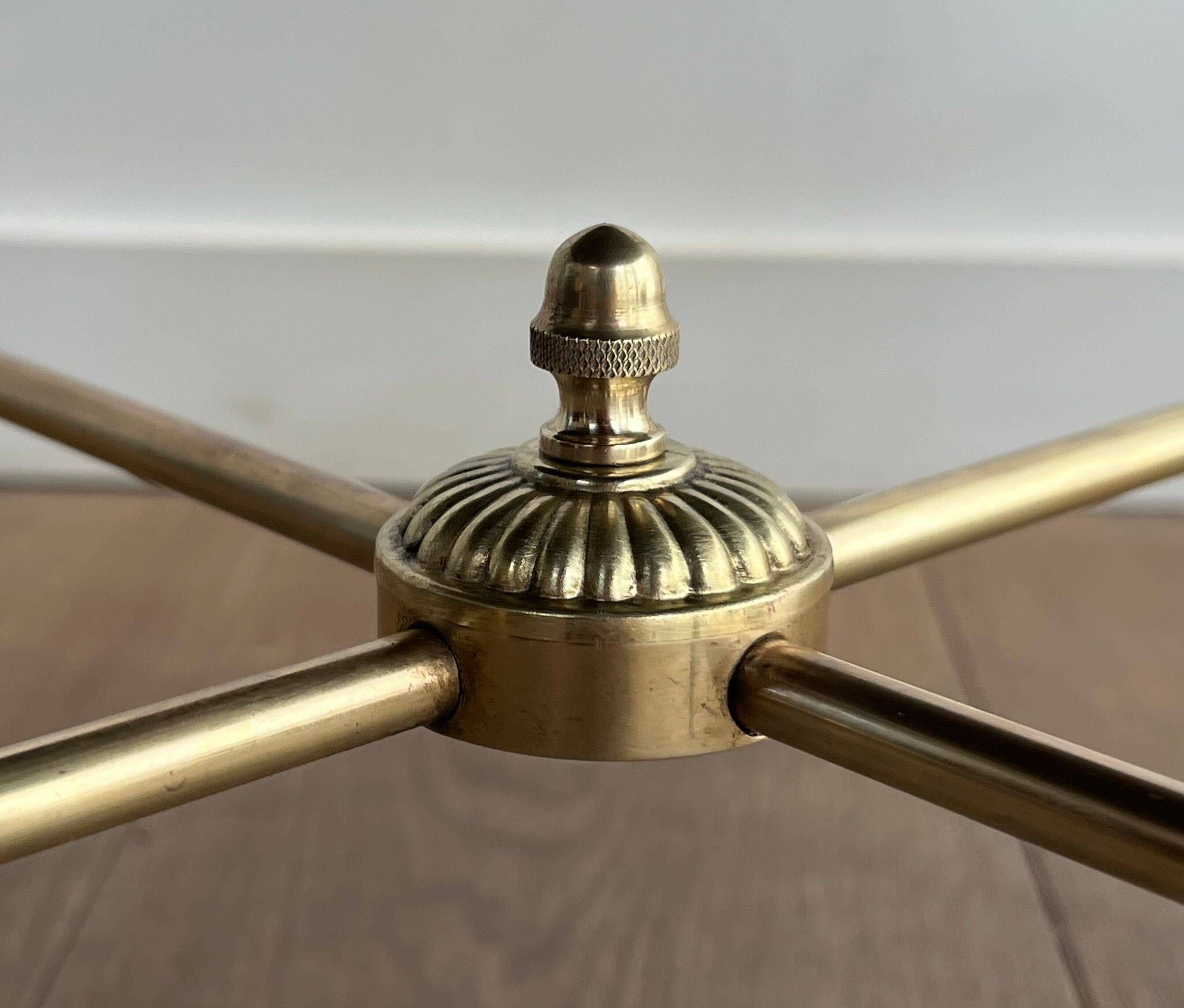 Round coffee table in brass with a black lacquered glass top from Maison Jansen.