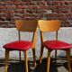 Set of 4 vintage bistro chairs in wood and red faux leather, with splayed legs.