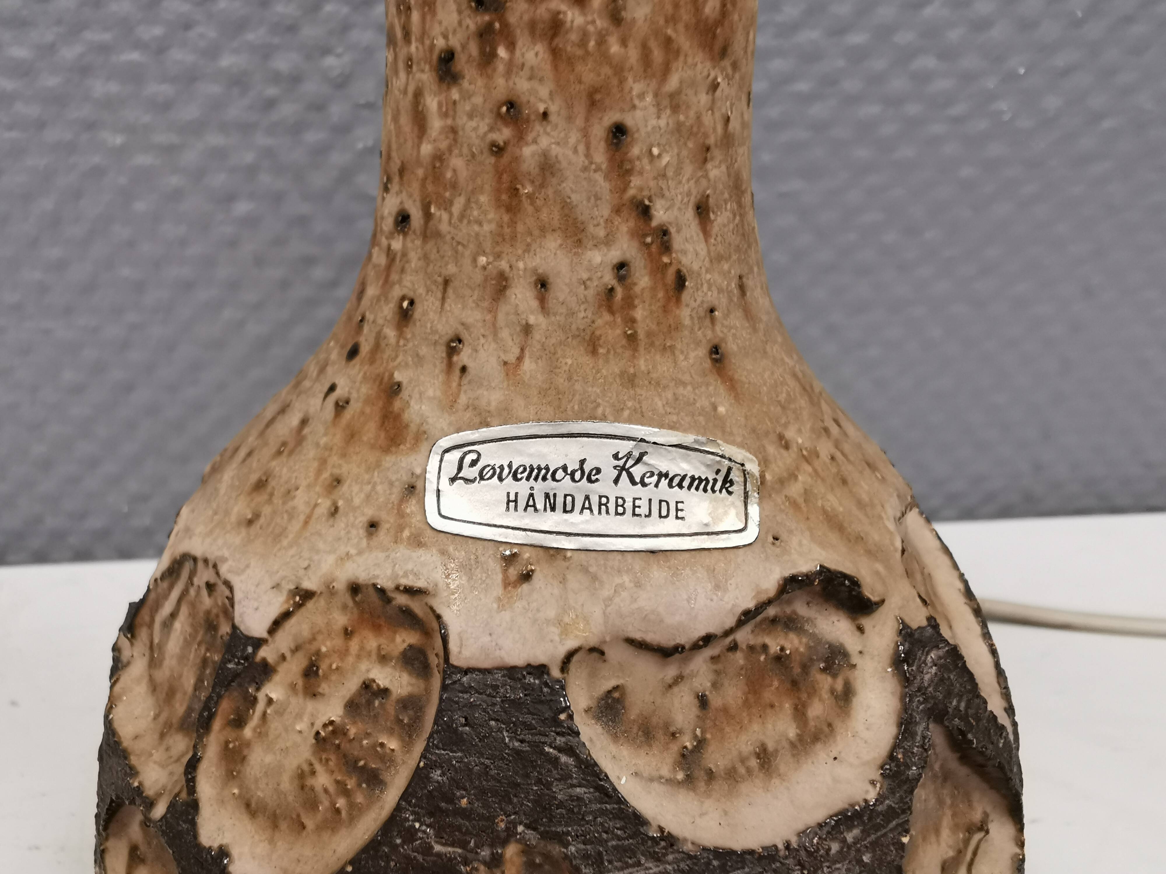 Small beautiful ceramic table lamp in earth colors.