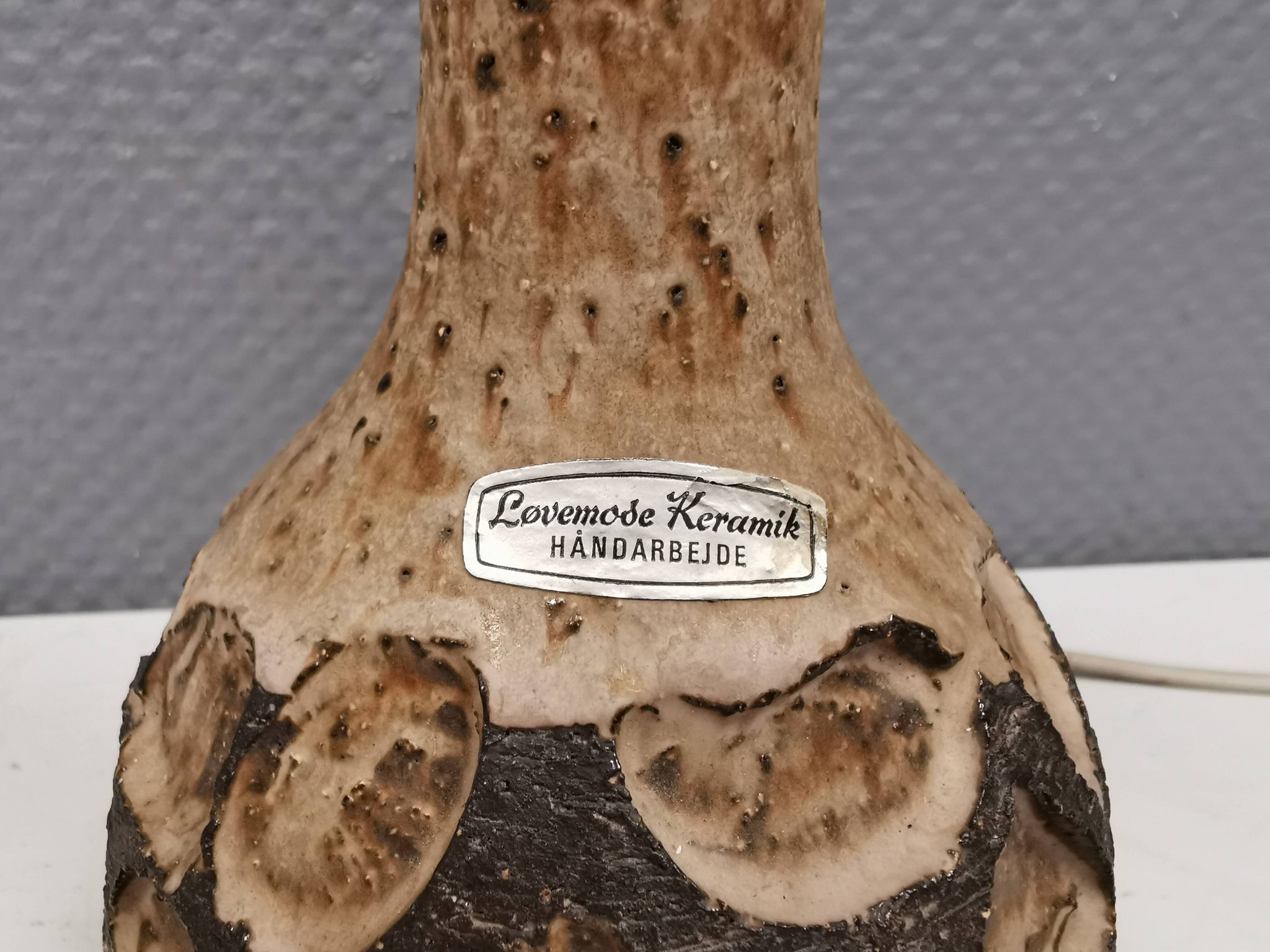 Small beautiful ceramic table lamp in earth colors.