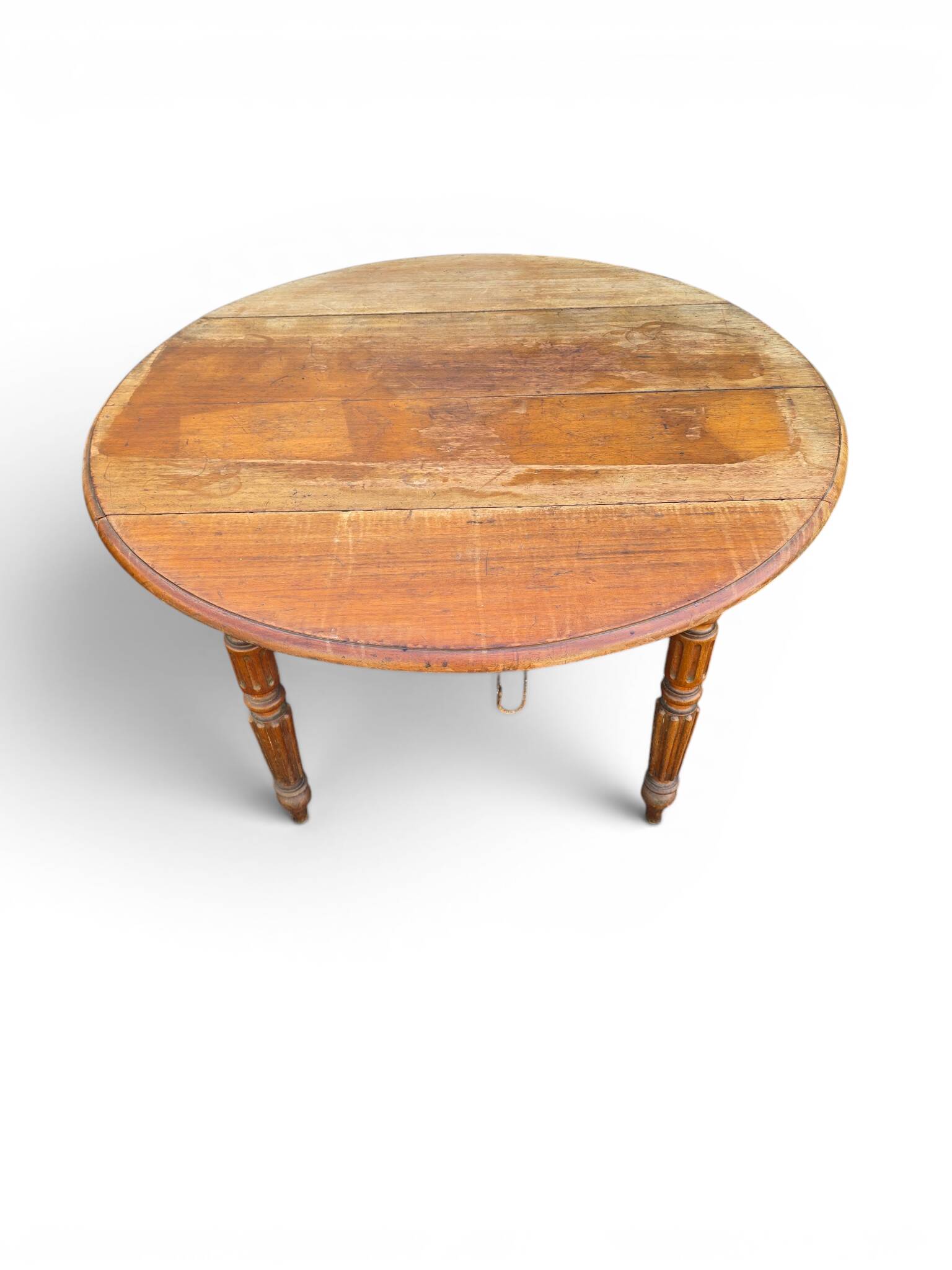 Antique drop-leaf table in wood, with turned legs and castors.