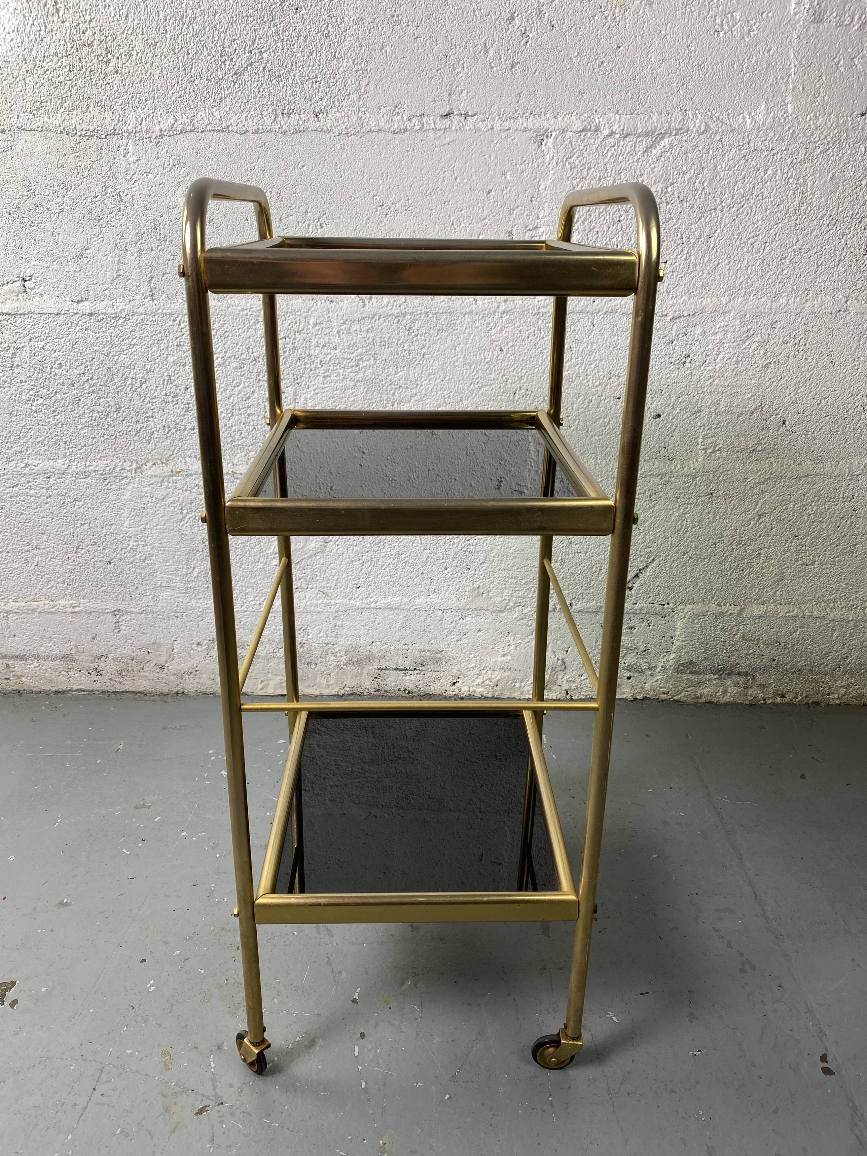Small rolling trolley in brass and black plastic