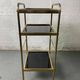 Small rolling trolley in brass and black plastic