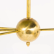 8-light brass chandelier and white-black and gold day blinds