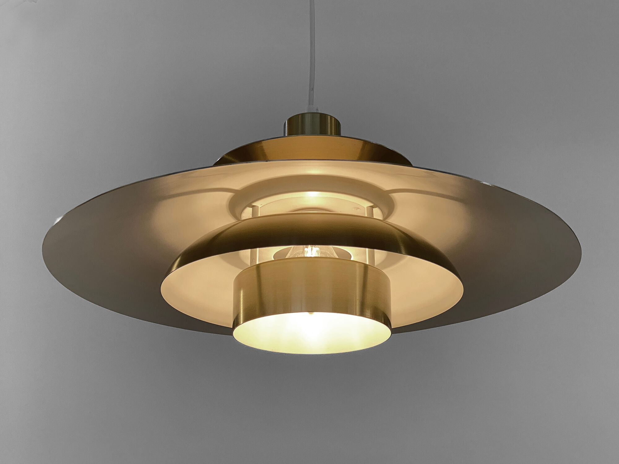 Golden colored aluminum pendant light from Frandsen Lighting. Denmark 1970s
