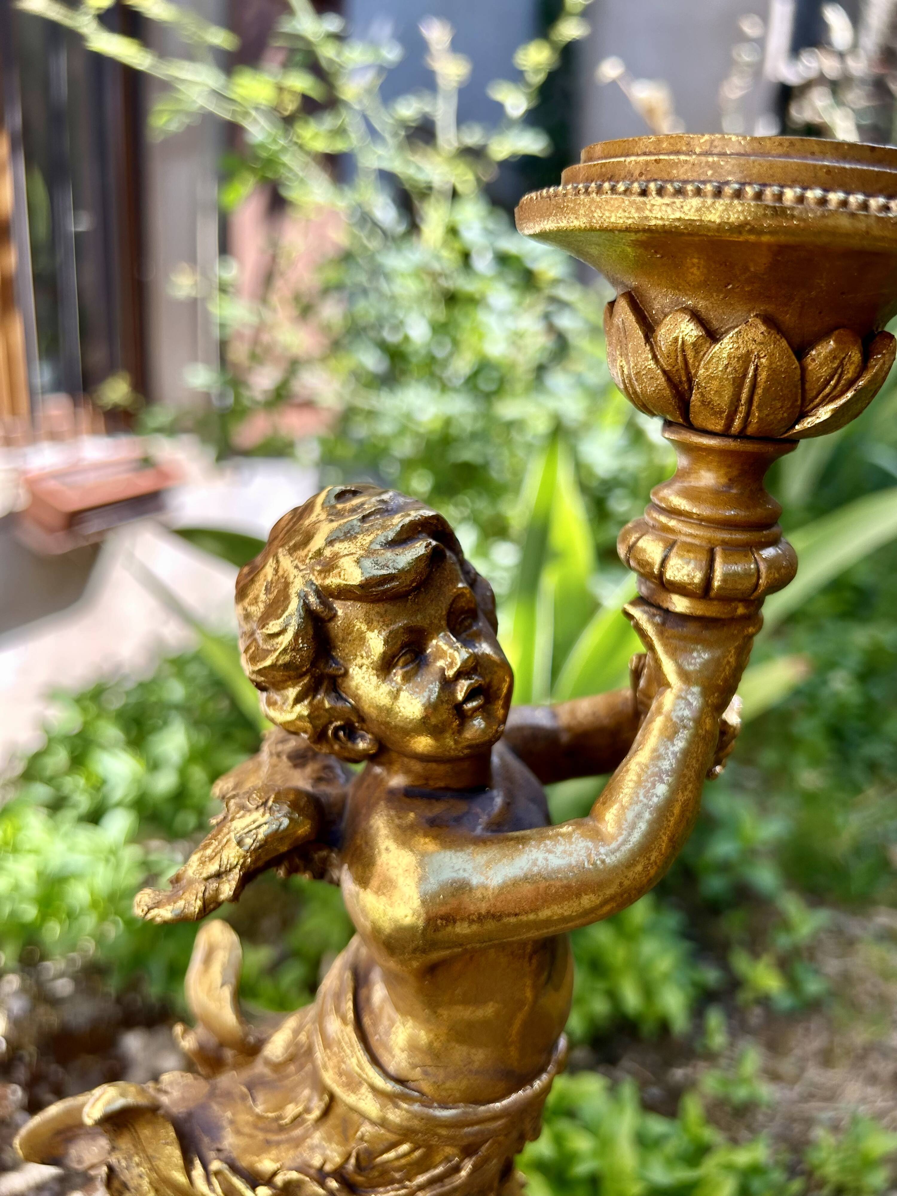 Pair of large candlesticks with cherubs