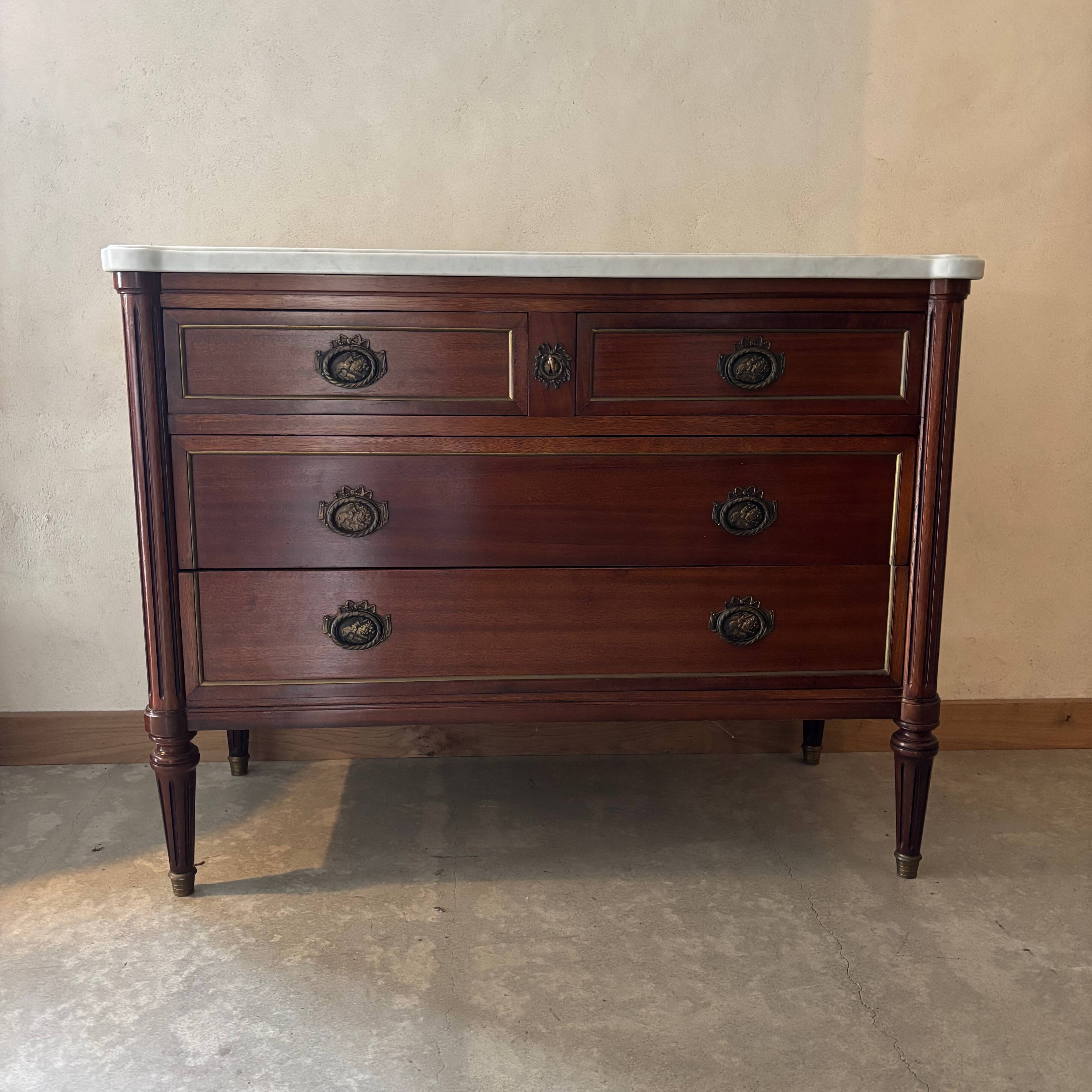 Louis XVI style commode with a shaped marble top.