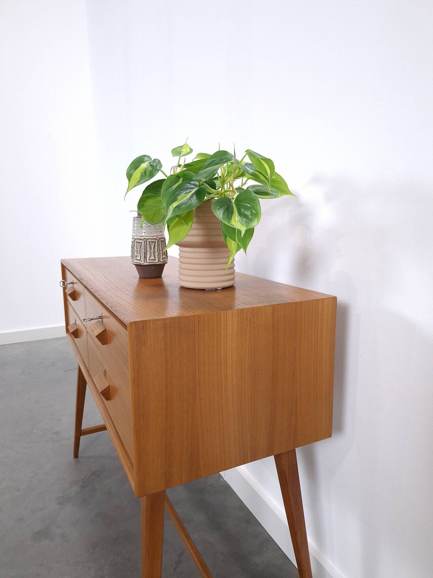 Vintage teak Danish chest of drawers with high slanted legs, side table, sideboard.