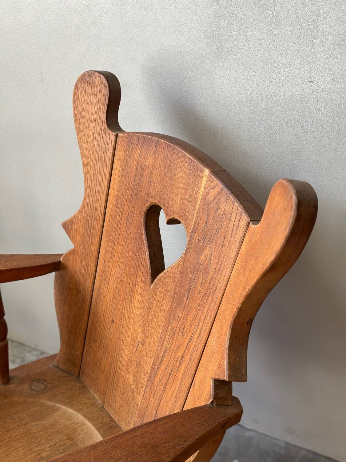 Pair of rustic oak armchairs – carved heart backrests