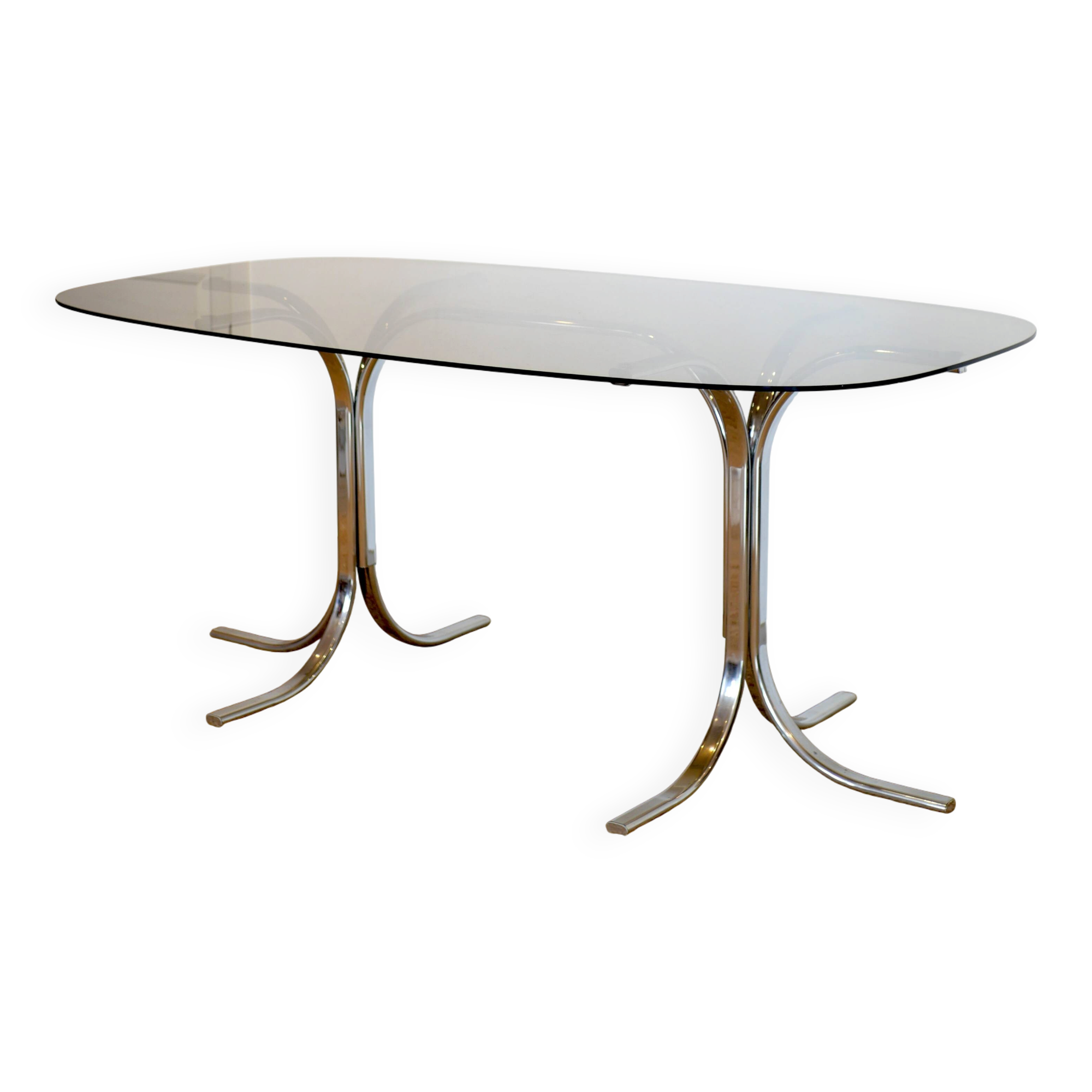 Dining table with smoked glass top and chrome base.