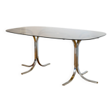 Dining table with smoked glass top and chrome base.