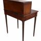 Antique mahogany step desk with a sliding shelf, ideal for small spaces.