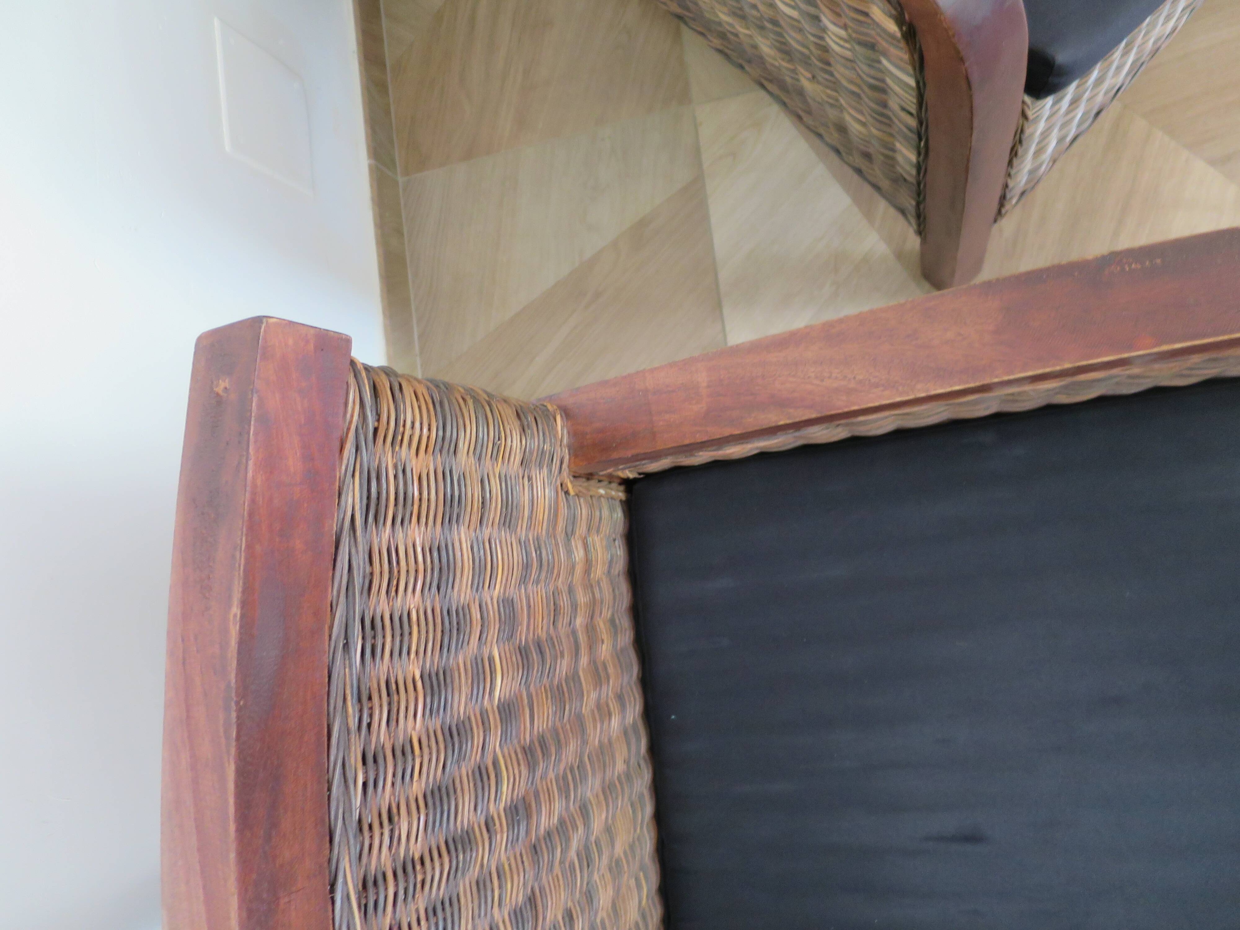 2 colonial-style armchairs in woven rattan and exotic wood