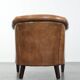 Characterful club chair made of sheepskin leather with light cognac colours