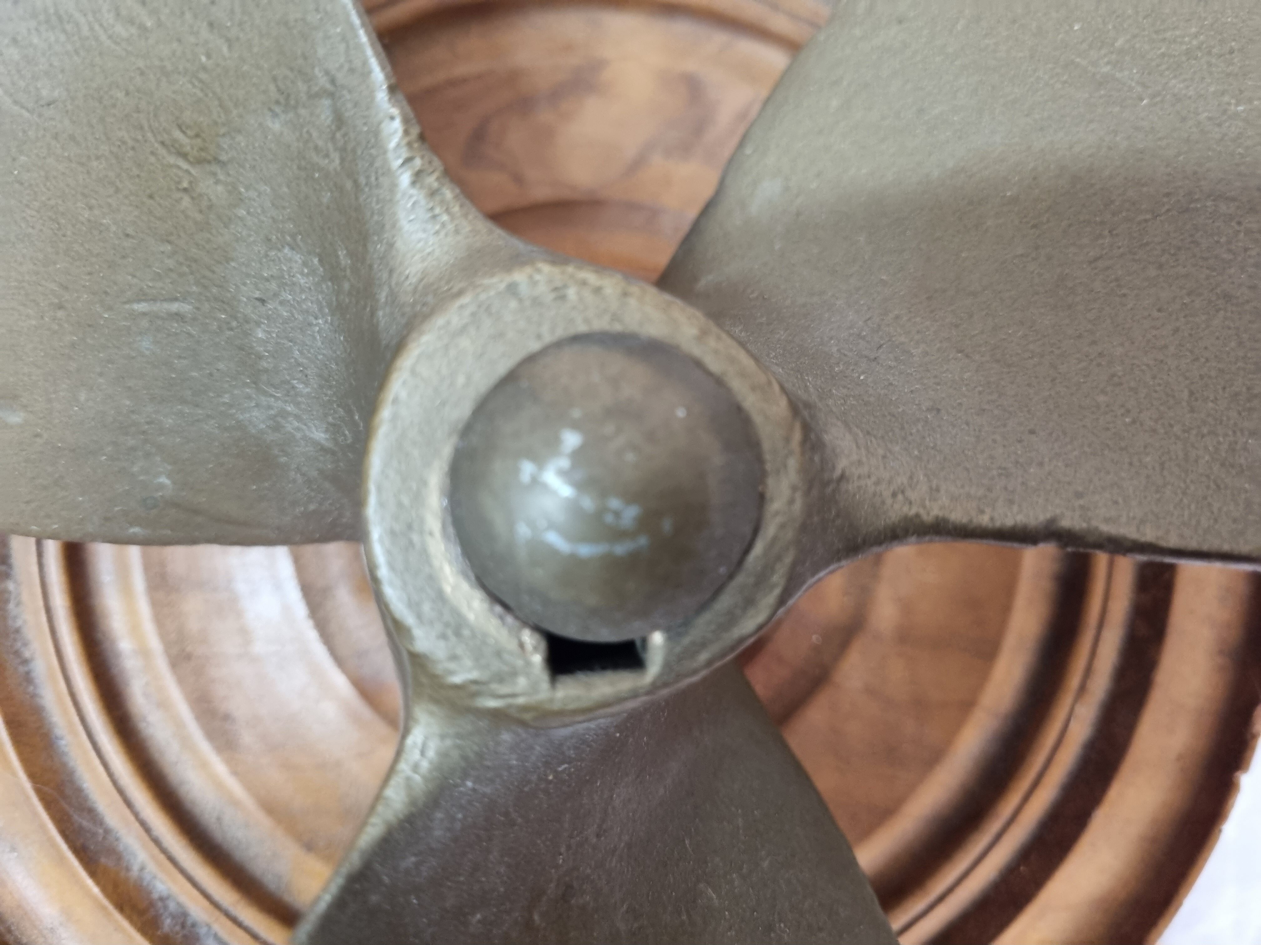 Bronze boat propeller on wood