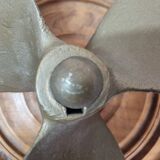Bronze boat propeller on wood