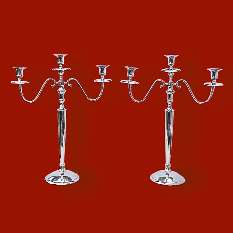 Pair of vintage three-armed chrome metal candlesticks