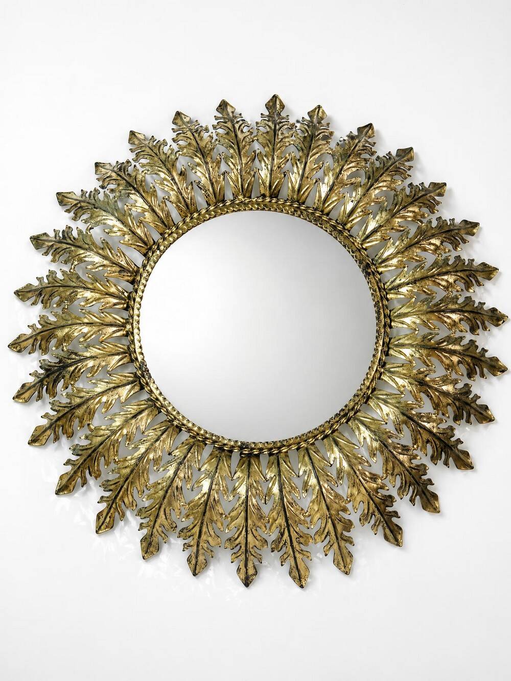 Large Italian sunburst wall mirror in gilded metal, 1960s-70s.