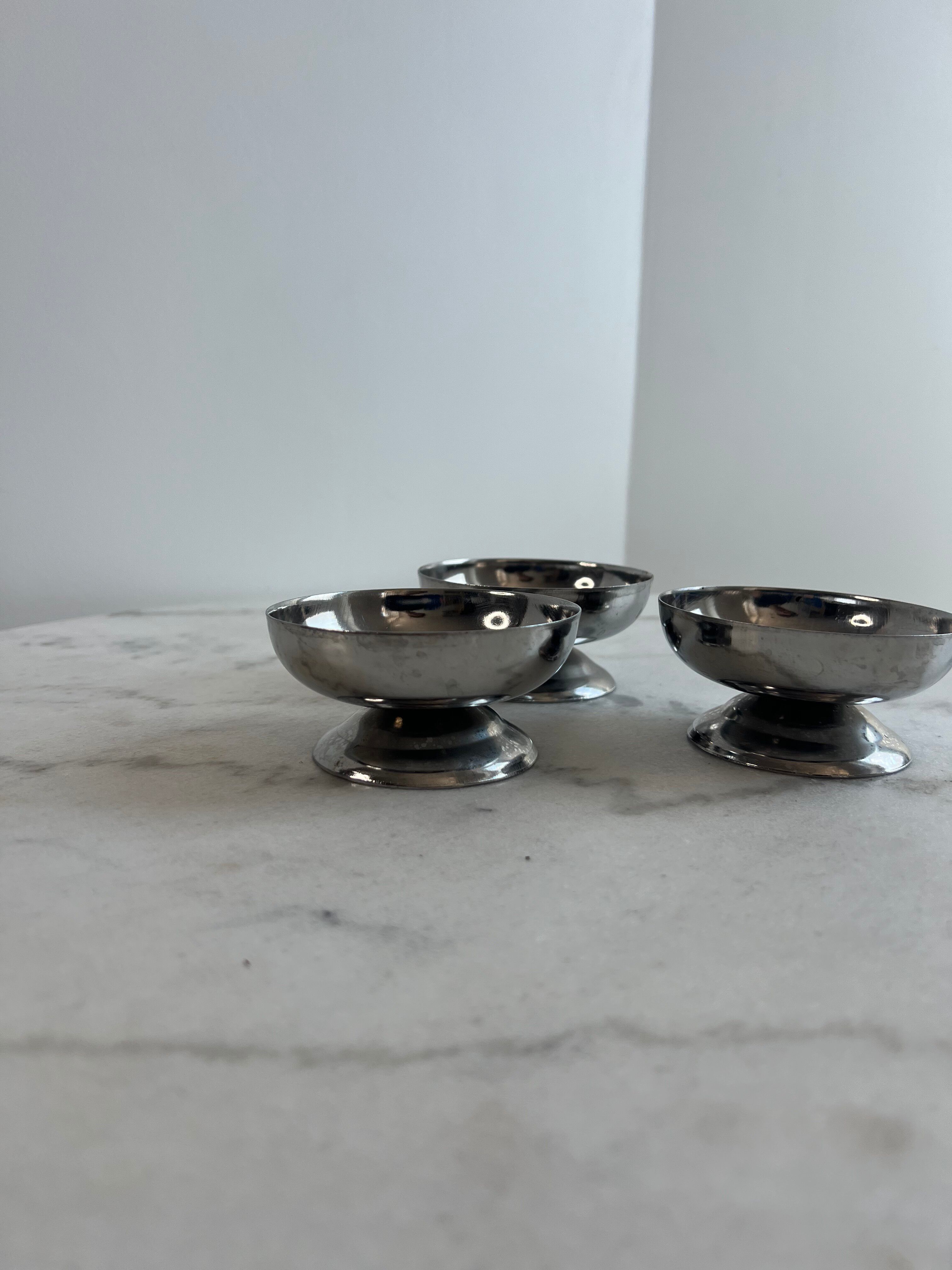 Set of 3 stainless steel dessert bowls on stands.