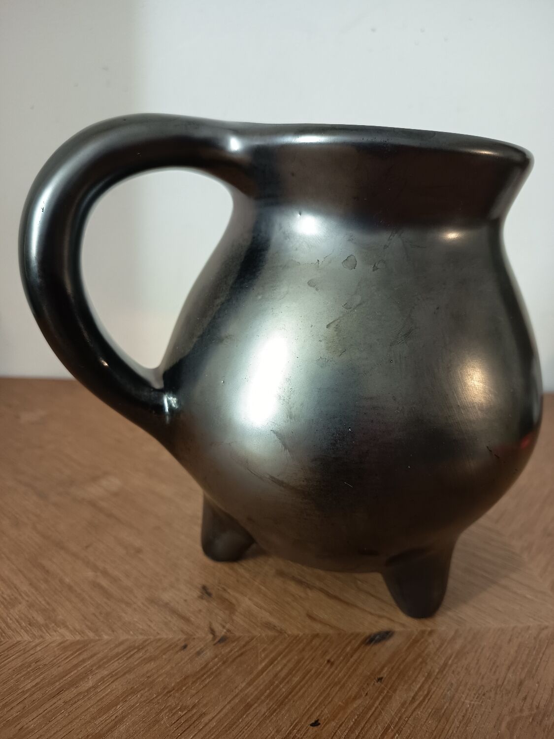 Black ceramic tripod jug