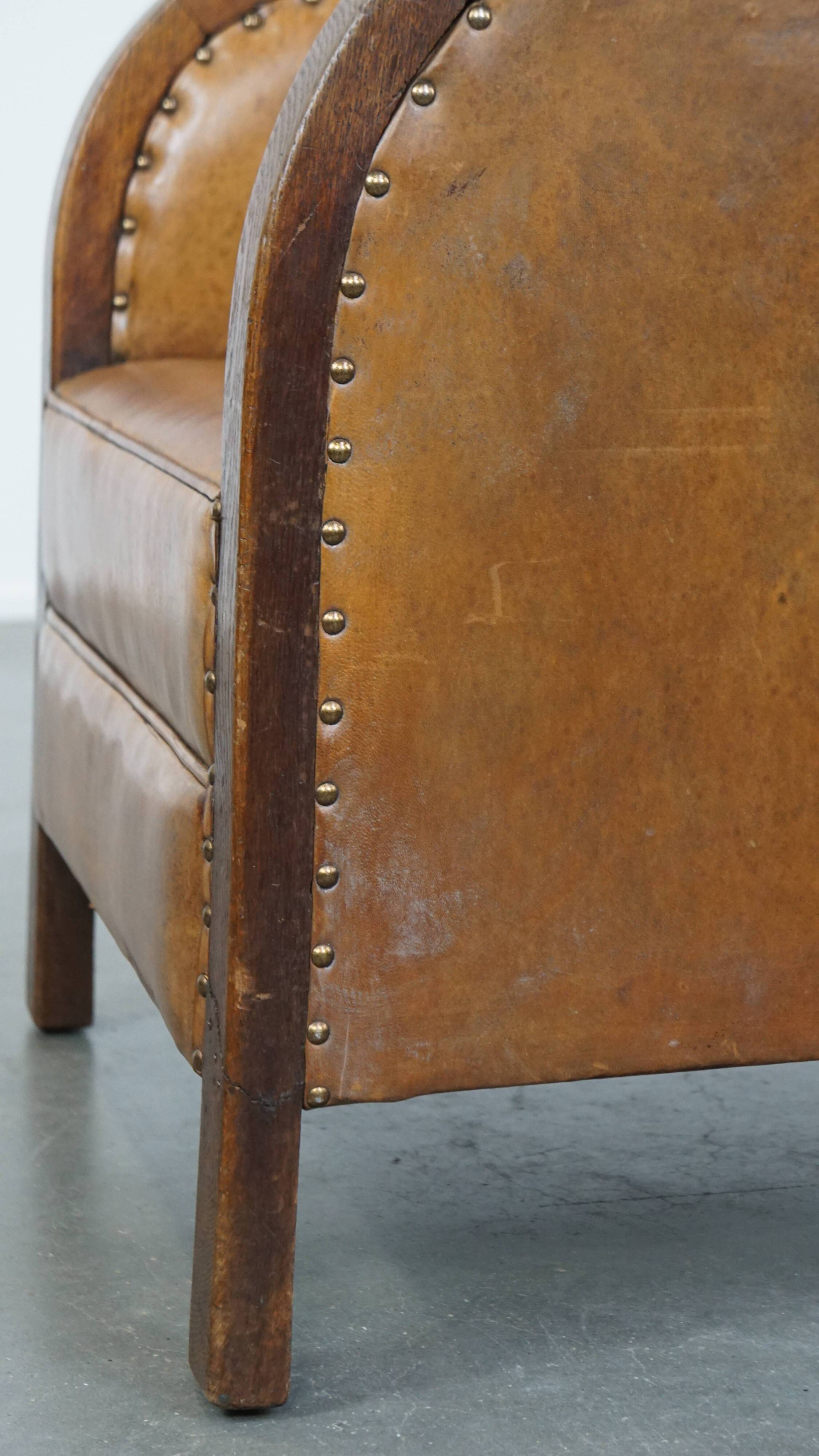 Cognac-colored sheepskin and wooden Art Deco design armchair