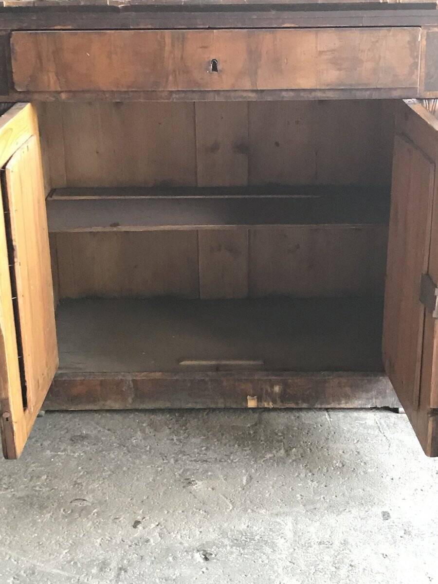 Vintage brown pine dresser with a painted top, moulded panels, and decorative locks.