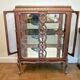A Louis XV style display cabinet with three beechwood shelves and a white marble top.