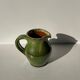Green glazed ceramic pitcher
