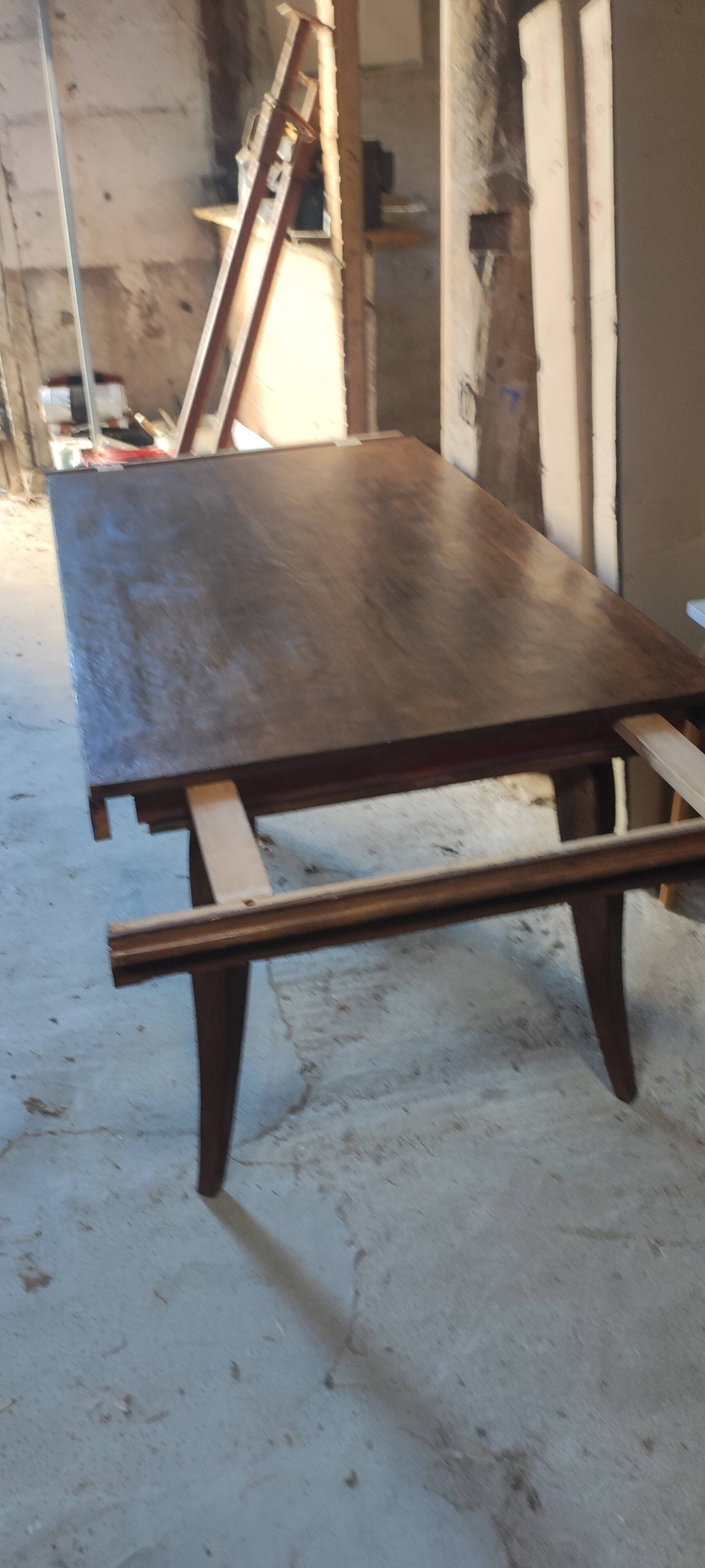 Solid oak dining table with integrated extensions.