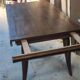 Solid oak dining table with integrated extensions.